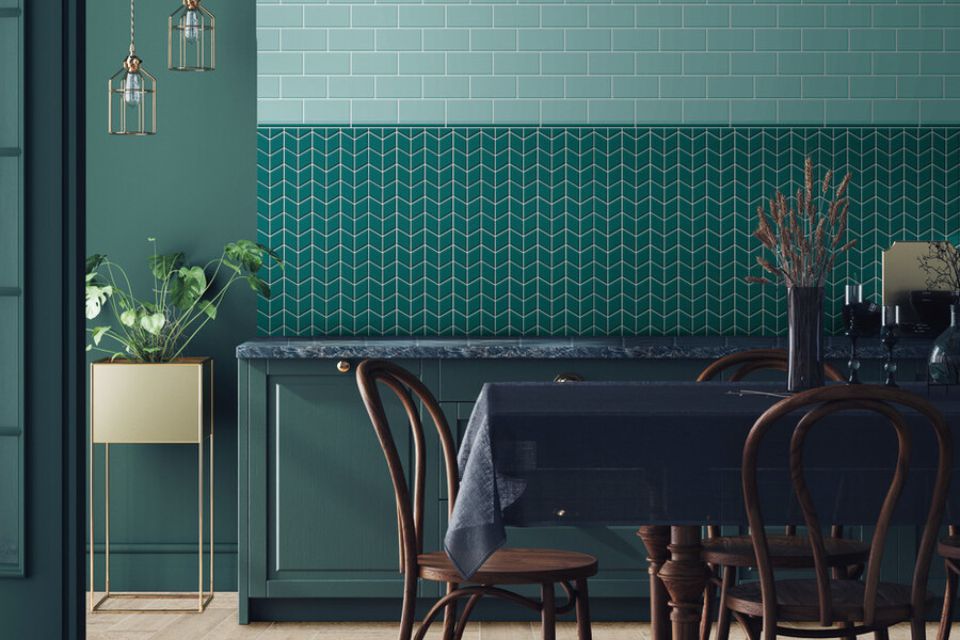 Daltile green tiles provide a stunning backsplash in a dining room with shades of green